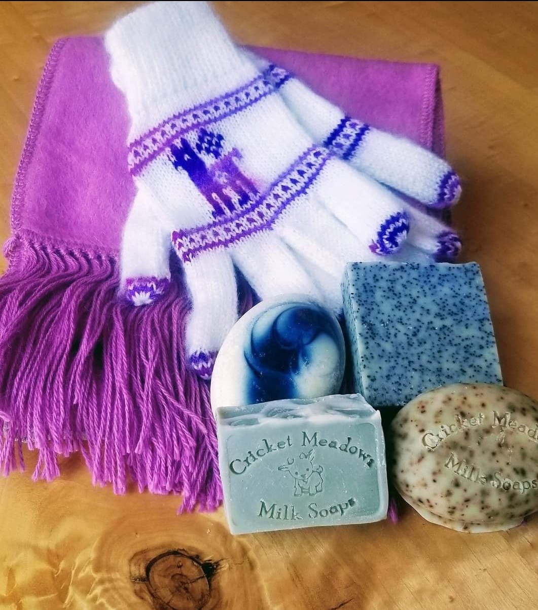 Assorted Cricket Meadows soaps with cozy mitts and a scarf.